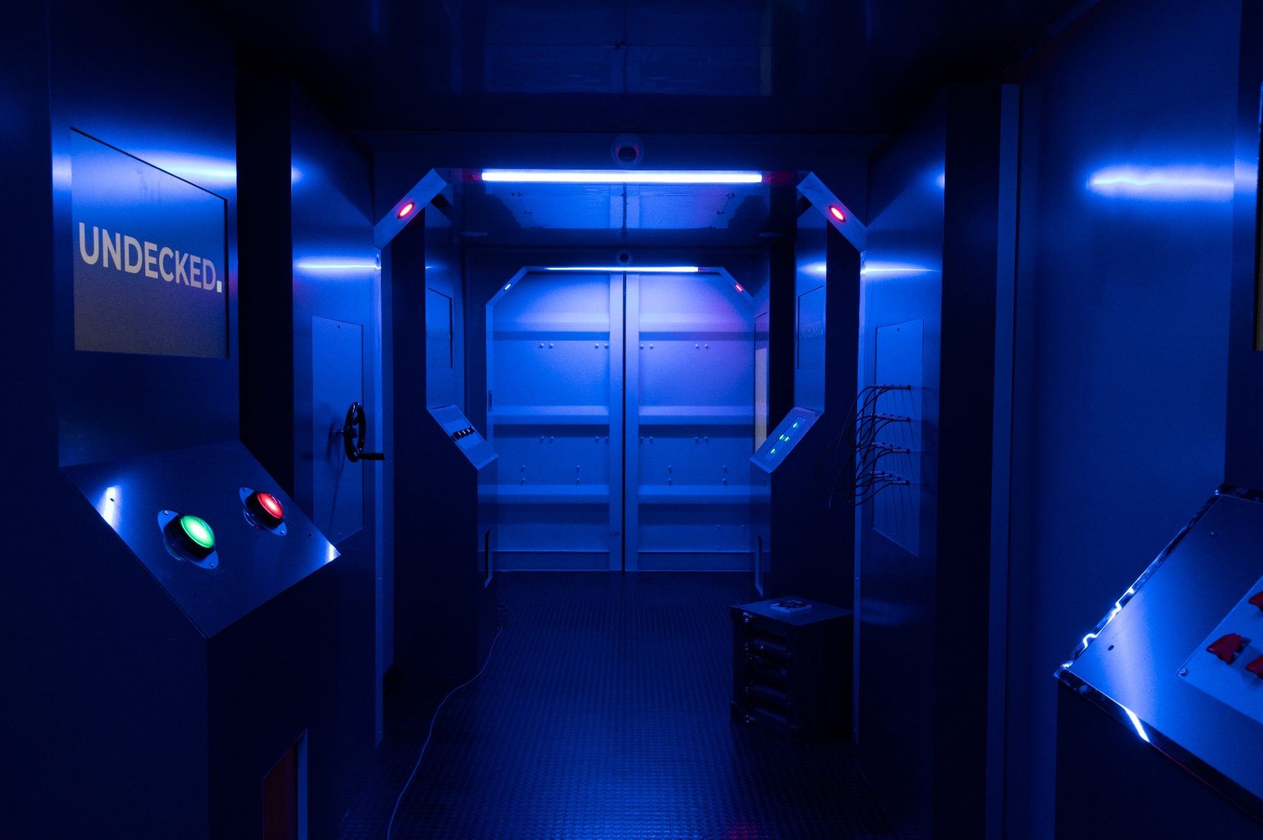 Threshold — the chamber entry under pressure lighting.